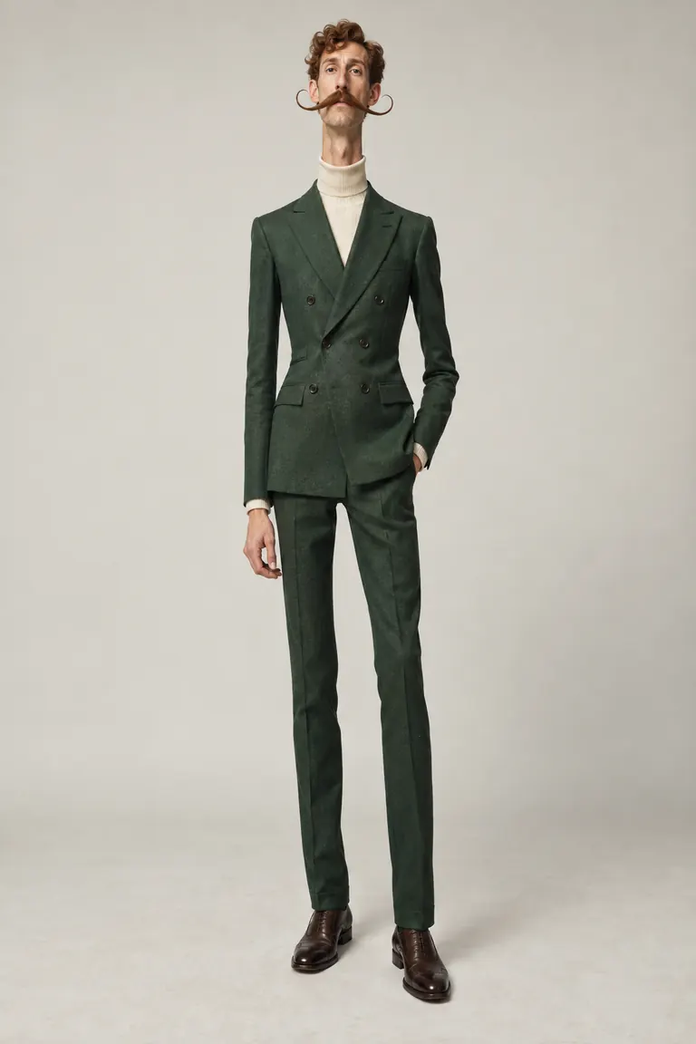 Tall, slim character in a green suit with a curled moustache