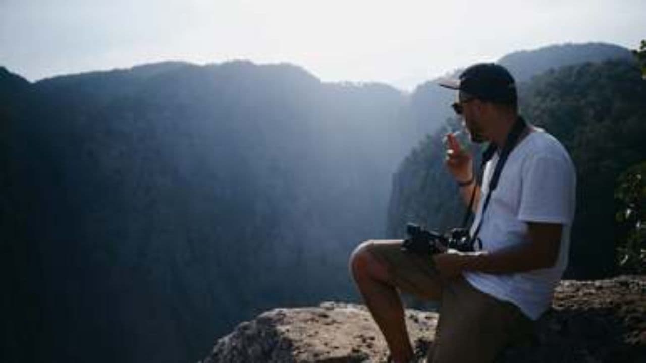 Man on Rock in Scenic Landscape
